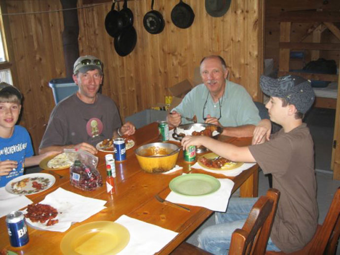 Enjoying a meal together at Wapesi Lake in Northern Ontario, Canada
